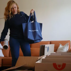 Woman packing moving boxes with tote bag
