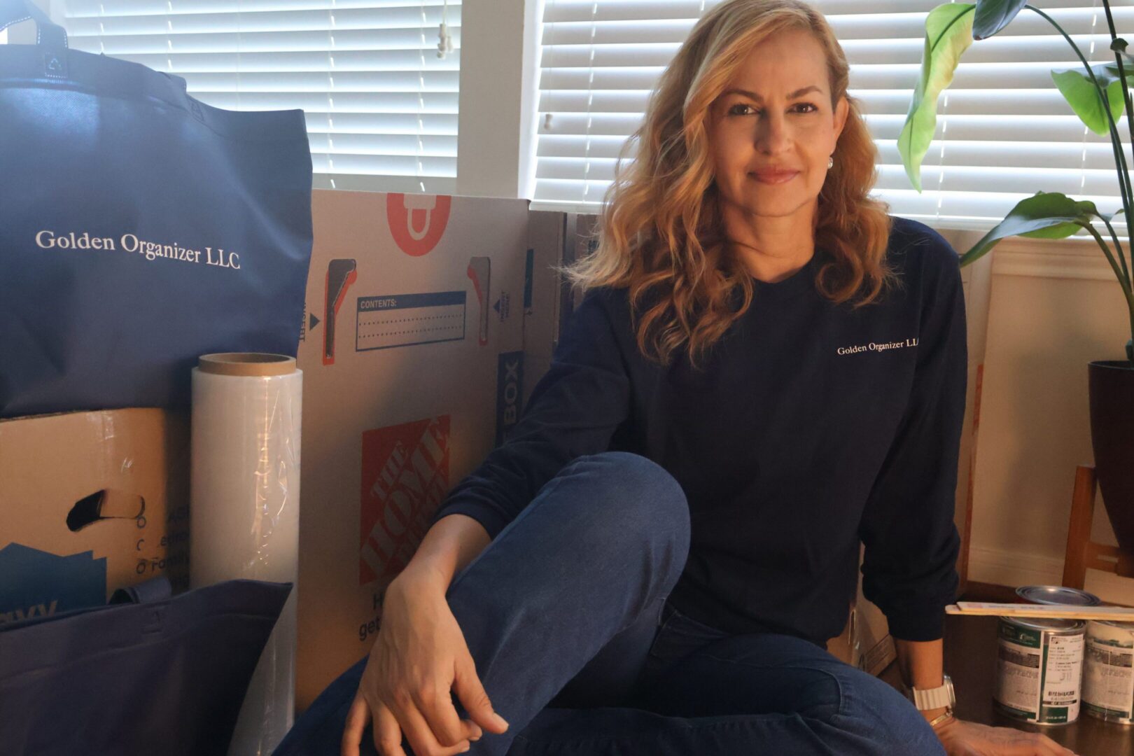 Smiling woman with moving boxes and supplies